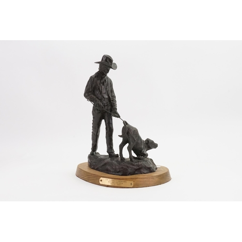 712 - A Richard Muno painted & Cast Sculpture depicting a Cowboy branding a calf entitled 