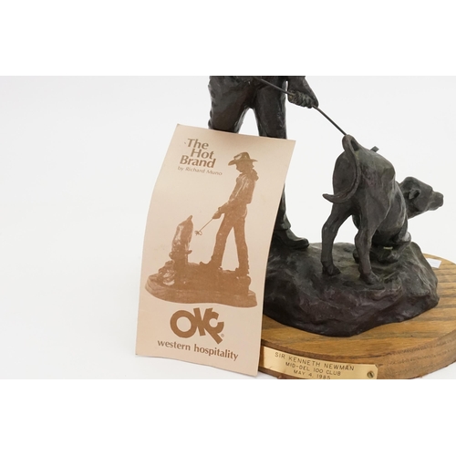 712 - A Richard Muno painted & Cast Sculpture depicting a Cowboy branding a calf entitled 