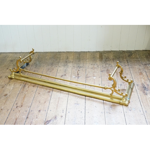 734 - A Victorian Brass Scroll Over Fender. Measuring: 135cms across x 36cms deep.