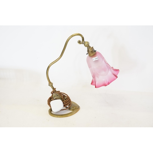 694 - An Art Nouveau design Brass effect Wall Light with a cranberry designed shade.