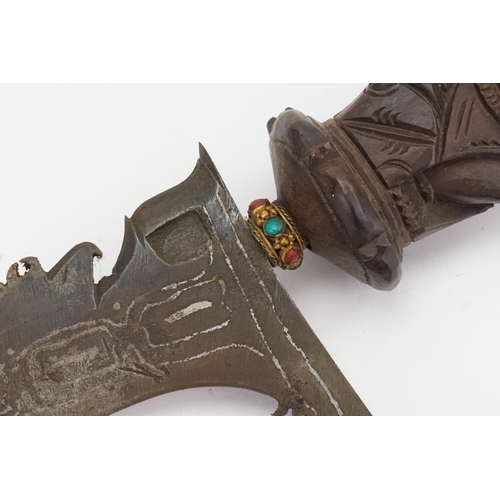 329 - A Malaysian Kris decorated with the lion god of a war contained in a carved scabbard with floral dec... 