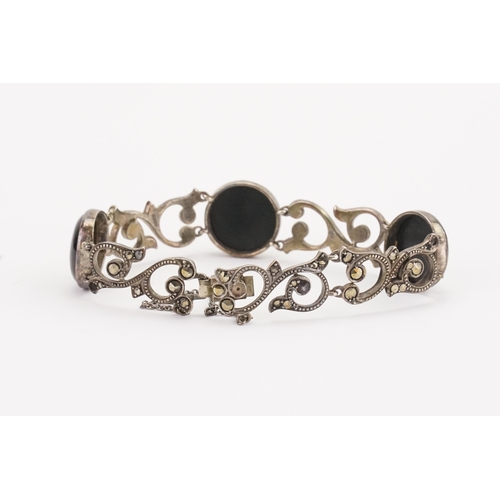 106 - A silver and onyx set bracelet. Weight 23g.