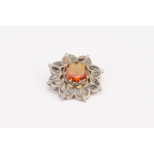 122 - A Scottish pebble brooch, set with granite, citrine and agate. Set in a silver mount, with a large c... 