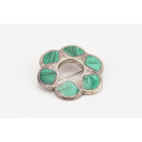 124 - A Scottish pebble brooch, set with malachite in a silver mount.