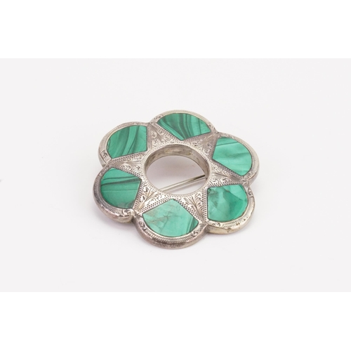 124 - A Scottish pebble brooch, set with malachite in a silver mount.