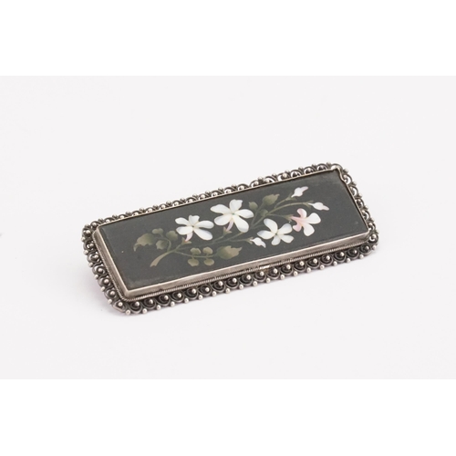 132 - An Antique Victorian Pietra Dura Brooch in a silver mount. 6.5cm x 2.5cm.