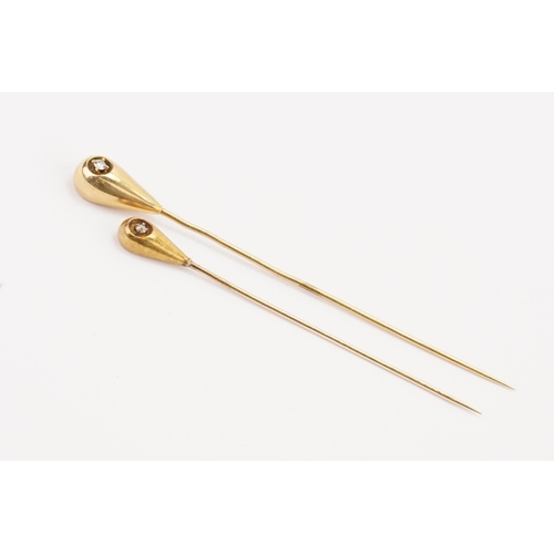 159 - A pair of 14ct gold diamond set stick pins. Weight 2.1g.