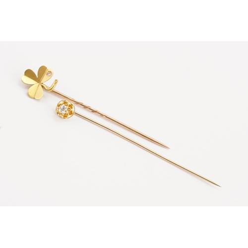 161 - A diamond set clover stick pin, along with another diamond stick pin.