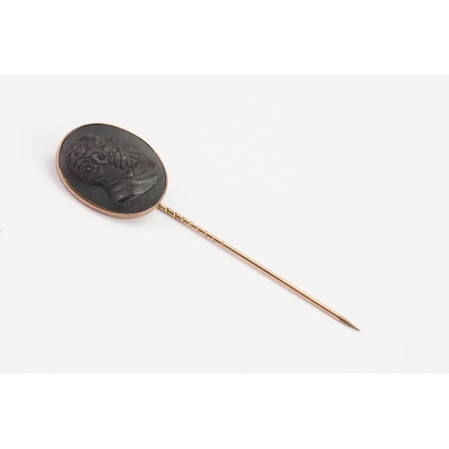 169 - A jet black cameo stick pin, depicting a gentleman.