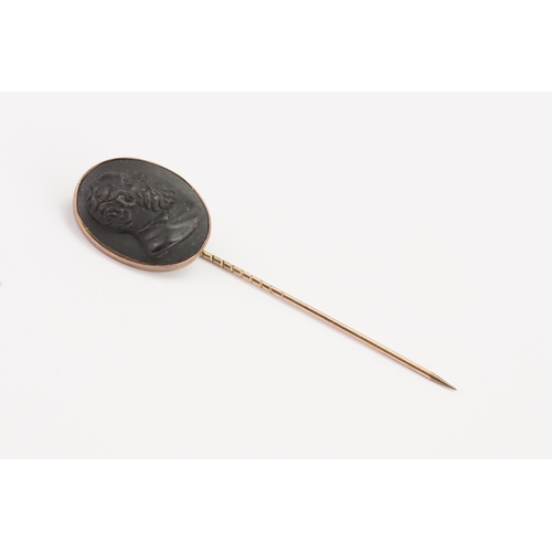 169 - A jet black cameo stick pin, depicting a gentleman.