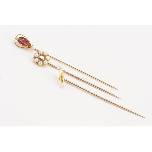 179 - A 18ct gold pearl set hoop stick pin, along with two others.