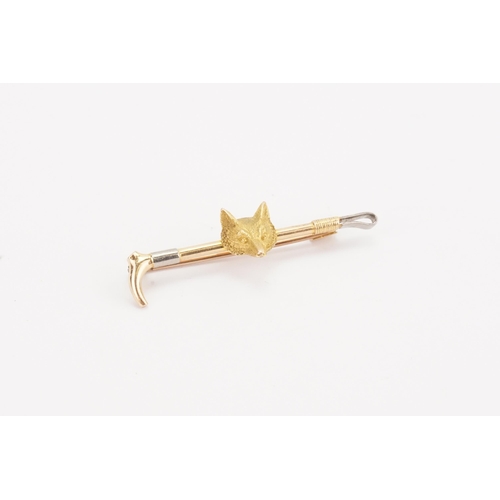 187 - A 15ct gold fox and cane brooch. Weight 4g.