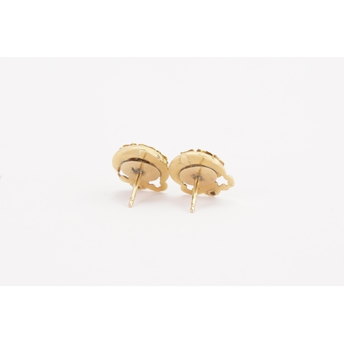 189 - A pair of gold coloured earrings, set with enamelled flowers. Weight 3g.