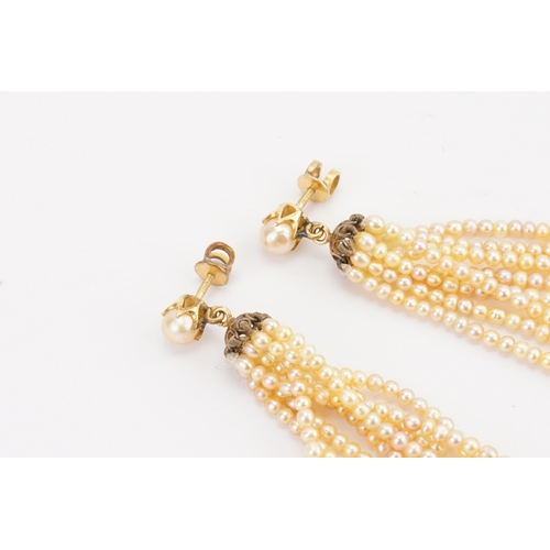 198 - A pair of gold mounted pearl set drop earrings, in the tassel design.