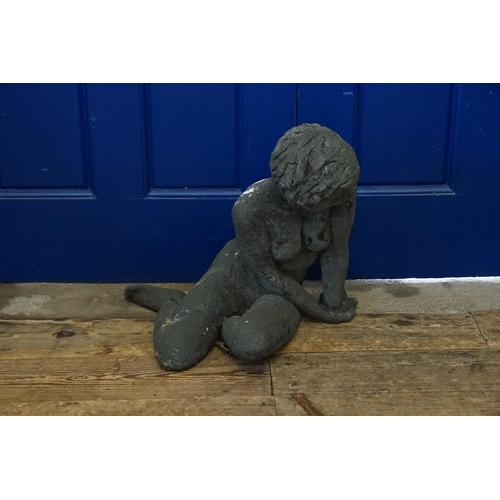 705 - A Very Heavy Garden Statue of a Nude Young Woman seated & crossed leg. Measuring: 45cms x 50cms.