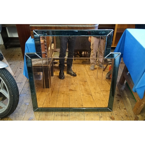 654 - A Modernistic design Peach Glass & Blue edged Hall Mirror. Measuring: 89cms across x 91cms high.