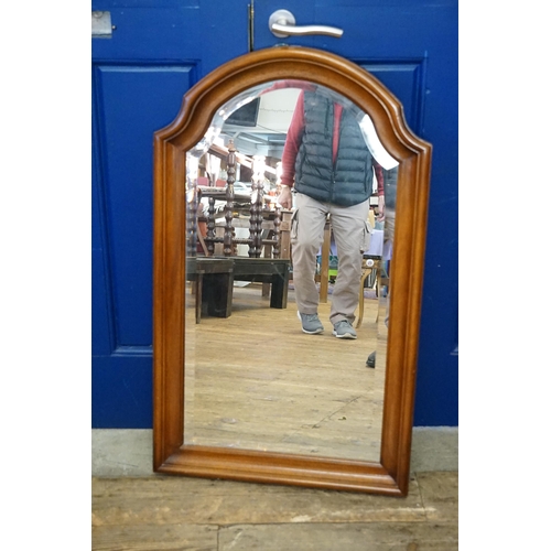 655 - A Walnut Framed Bevelled Glass Wall Mirror. Measuring: 97cms x 57cms.