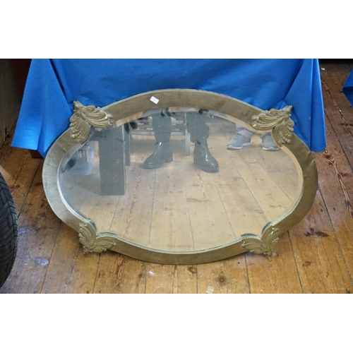 656 - An Edwardian Brass Framed Shaped Hall Mirror with Butterfly decoration. Measuring: 85cms x 65cms.