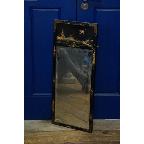 657 - A Black Lacquered Chinoiserie Wall Mirror possibly for Maple's. Measuring: 83cms x 34cms.