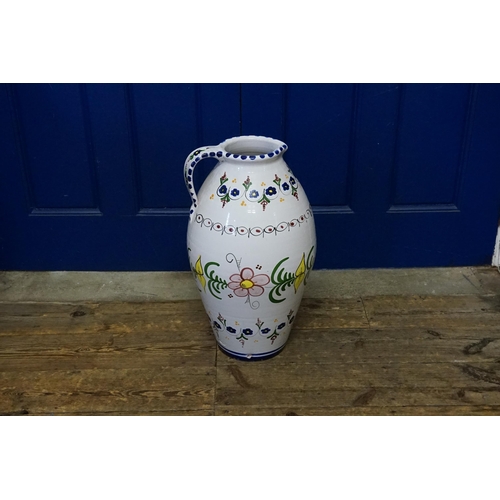 1035 - A Large Spanish Floral decorated painted Jug with a loop handle. Measuring: 58cms high.