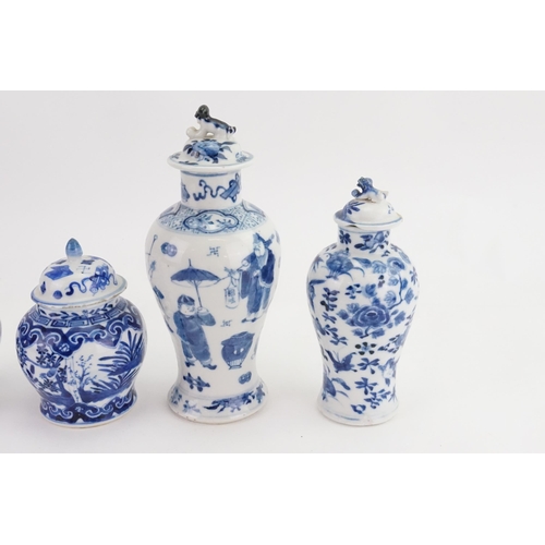 864 - Two Blue & White Ginger Jars with Covers & two vases decorated with a street scene, umbrella vendor,... 