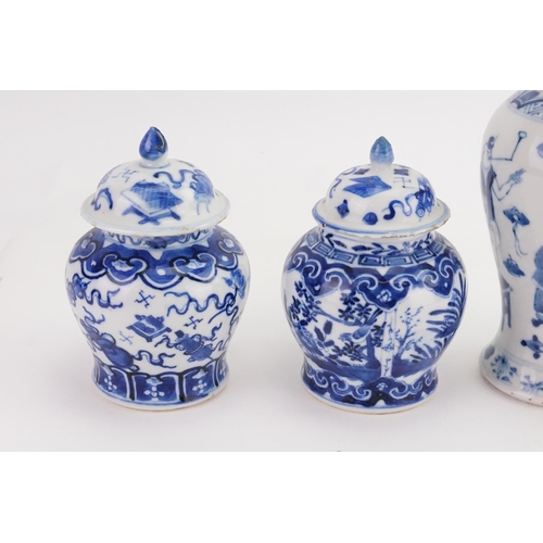 864 - Two Blue & White Ginger Jars with Covers & two vases decorated with a street scene, umbrella vendor,... 