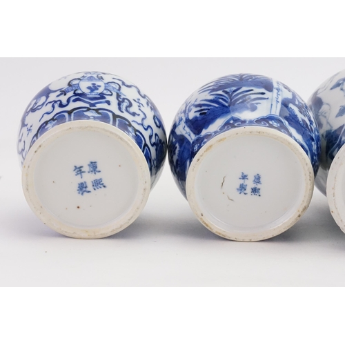 864 - Two Blue & White Ginger Jars with Covers & two vases decorated with a street scene, umbrella vendor,... 