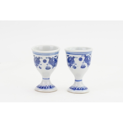 873 - A Pair of Chinese Blue & White Dragon decorated Egg Cups with Seal marks on Base.