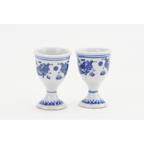 873 - A Pair of Chinese Blue & White Dragon decorated Egg Cups with Seal marks on Base.