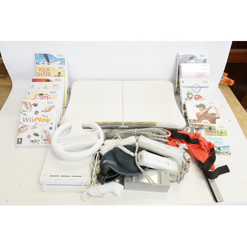 534 - A Nintendo Wii Console, Keep-Fit Pad, Steering Wheel, Four Controllers, Cables, etc along with 10 Ga... 