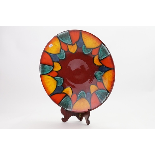 1044 - A Large Poole Pottery multi coloured Leaf designed & Rouge glazed Wall Dish. Measuring: 40cms across... 