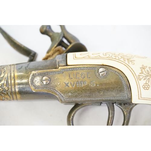 336 - Two Brass Duelling Cased Flintlock Pistols for the Reproduction market marked 