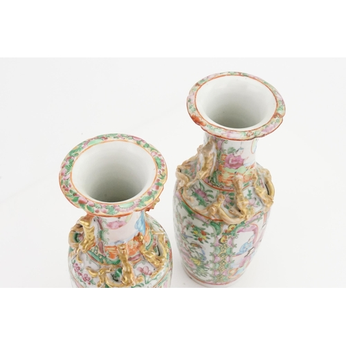 901A - A pair of mid-19th century Canton Famille rose porcelain vases. Decorated with dragon handles and st... 