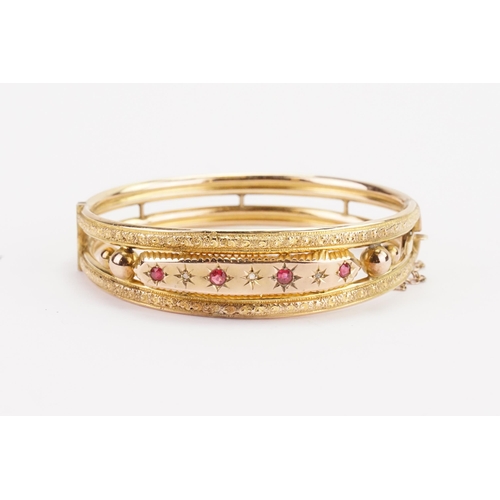 119 - A Victorian 9ct gold diamond and ruby set bangle. Weight 10.8g.