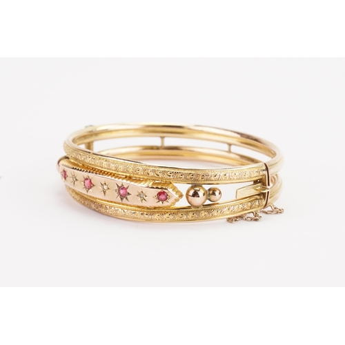 119 - A Victorian 9ct gold diamond and ruby set bangle. Weight 10.8g.