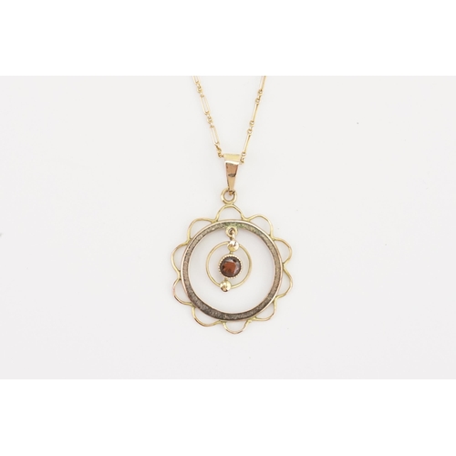 123 - A 9ct gold Victorian drop pendant, set with a garnet hung on a 9ct gold chain. Weight 2.8g.