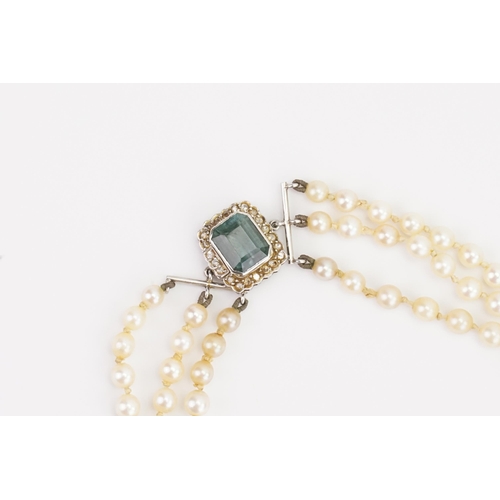 128 - A set of pearls with a diamond and indicolite clasp. Indicolite approx 9.5mm x 7.7mm. Set with 22 di... 