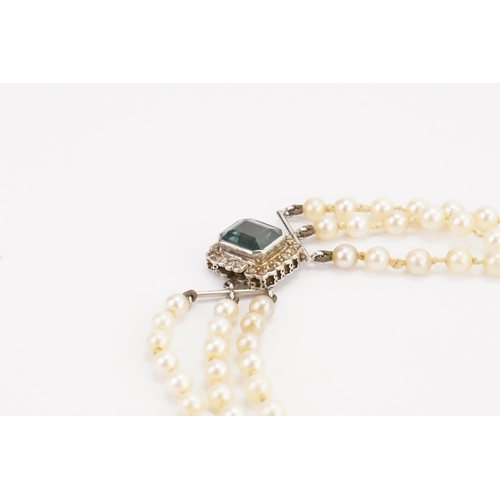 128 - A set of pearls with a diamond and indicolite clasp. Indicolite approx 9.5mm x 7.7mm. Set with 22 di... 