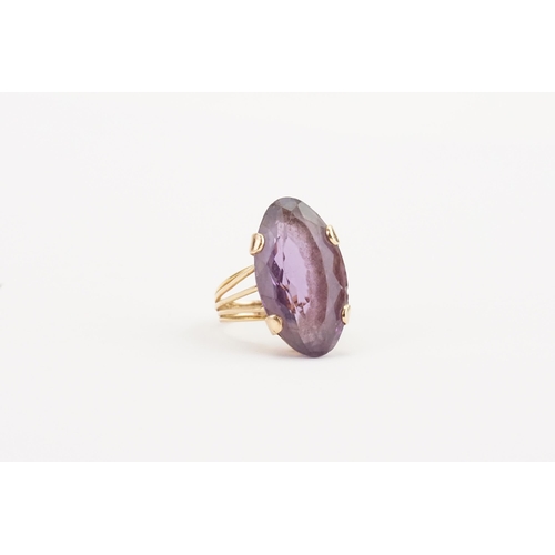 61 - A higher than 9ct gold amethyst ring, set with a large marquise amethyst (25.9mm x 14.6mm). Weight 9... 