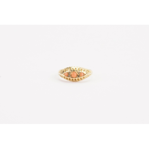 131 - A 18ct gold coral and diamond set ring. Set with three coral stones. Weight 2.9g. Size P.