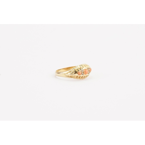 131 - A 18ct gold coral and diamond set ring. Set with three coral stones. Weight 2.9g. Size P.