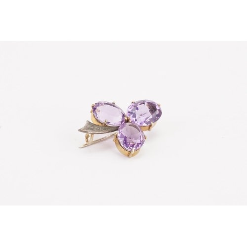 132 - A gold coloured and amethyst three leaf clover brooch. Weight 7g. Amethyst size approximately 13.9mm... 