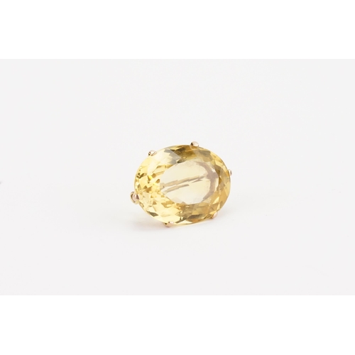 134 - A 9ct gold citrine set brooch, set with a large oval cut citrine (30mm x 22.8mm). Weight 13.7g.