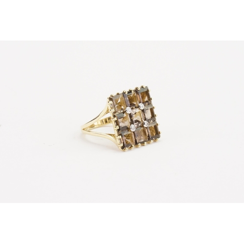 138 - A 585 marked gold ring, set with 9 smoky quartz and four diamonds. Weight 6.4g. Size P.