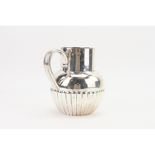 30 - A London 1896 Victorian silver jug, maker Thomas Bradbury & Sons, with ribbed design. Weight 383g.