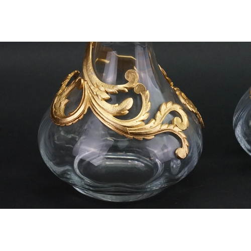 186 - A pair of Cristallin boussu souffle bouche glass decanters, decorated with gold gilt.