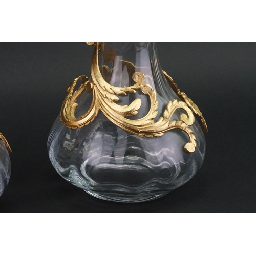 186 - A pair of Cristallin boussu souffle bouche glass decanters, decorated with gold gilt.