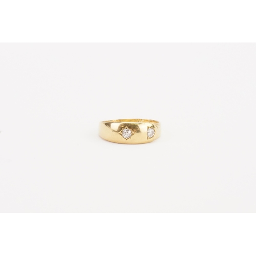 67 - A 18ct gold diamond set ring, set with two 0.1ct diamonds. In the belt design. Weight 6g. Size V.