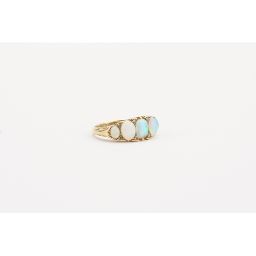 73 - A 18ct gold opal set ring, set with 5 opals. Weight 6.1g. Size P.