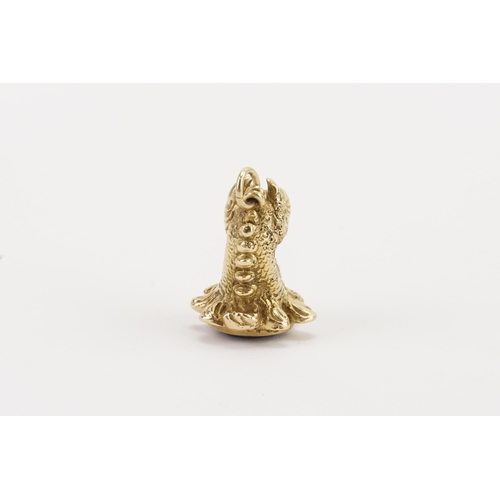 143 - A 9ct gold ruby eye dragon seal, with quartz base. Weight 33g.